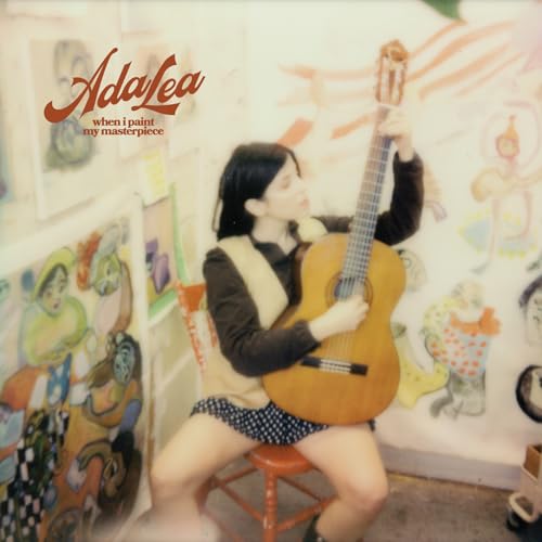Woman with acoustic guitar surrounded by colorful artwork.
