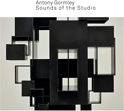 Dark metal sculpture with open cuboids against a white background.