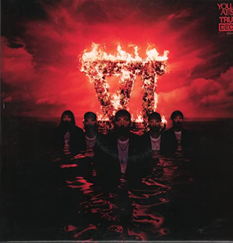 You Me At Six album cover: band in water, burning structure above.