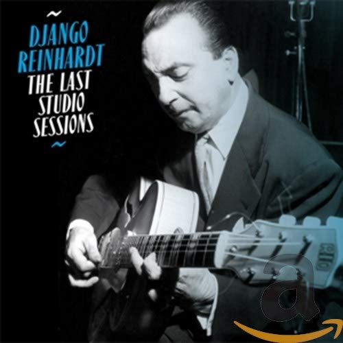 Black and white photo of Django Reinhardt playing an acoustic guitar.