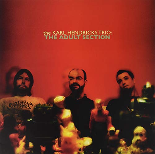 Album cover for The Karl Hendricks Trio’s “The Adult Section” with three men and dolls.
