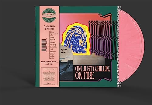 Vinyl record with colorful abstract album art and pink-colored disc.