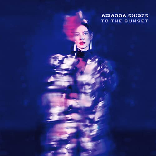 CD cover: woman with red hair and metallic clothing, blue background.