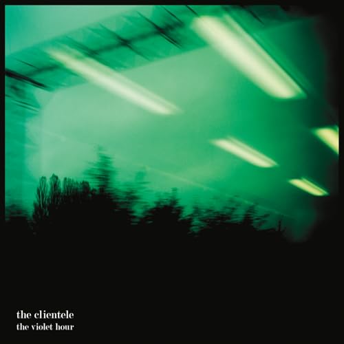 Green and black album cover with blurred lights and trees.