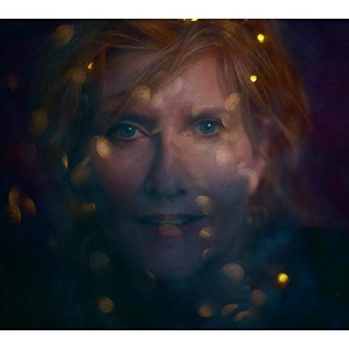 Close-up portrait of Eddi Reader with blurred golden lights.