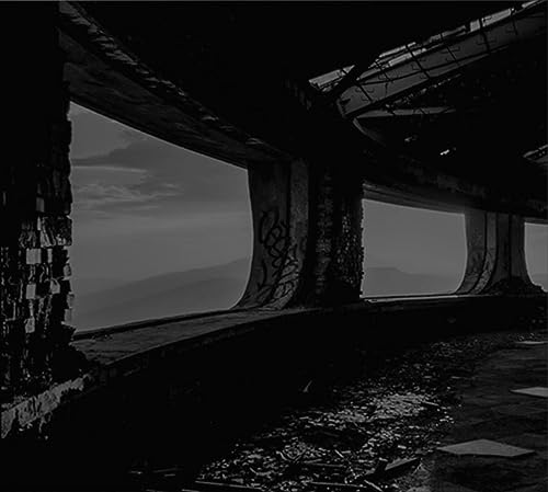 Dark, grainy image of a concrete underpass with a sky view.