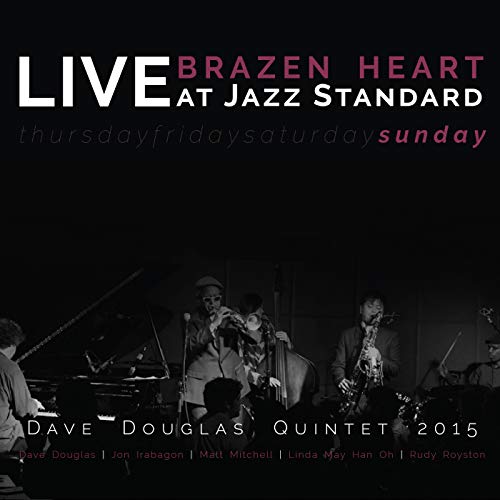 CD cover: jazz musicians performing live on stage, black and white.