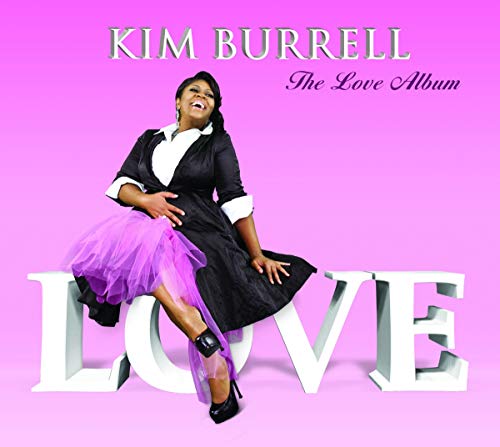 Kim Burrell sits near large, white block letters spelling "LOVE".