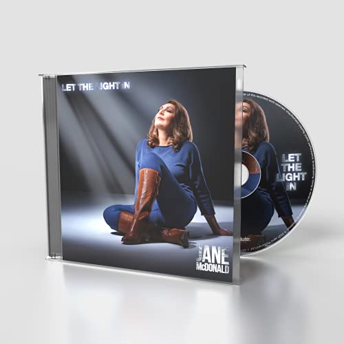Jane McDonald sitting in a blue outfit and brown boots on a CD cover.