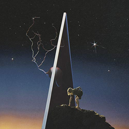 Album cover: a person before a monolith under a starry night sky.