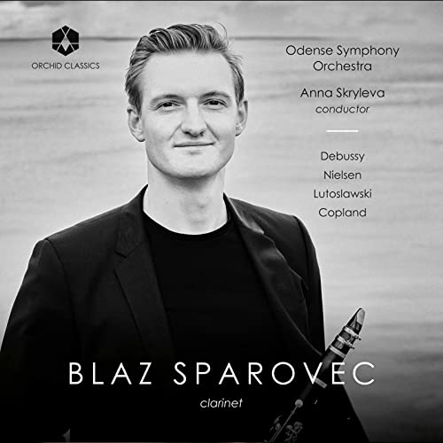 Black and white portrait of clarinetist Blaz Sparovec with his instrument.