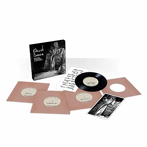 David Bowie vinyl box set with records, papers, and a photo.