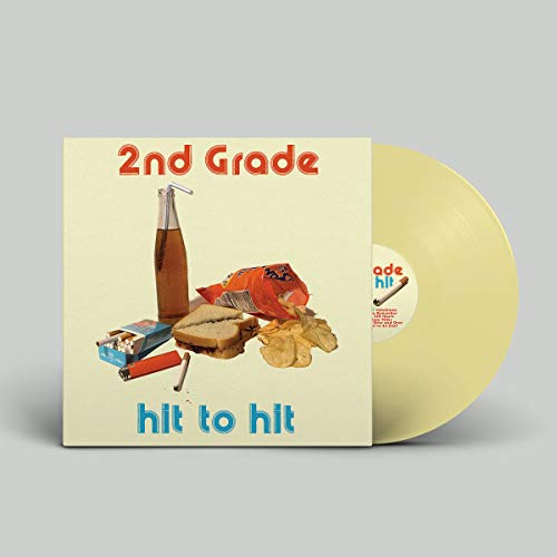 Yellow vinyl record with album cover featuring food and objects.