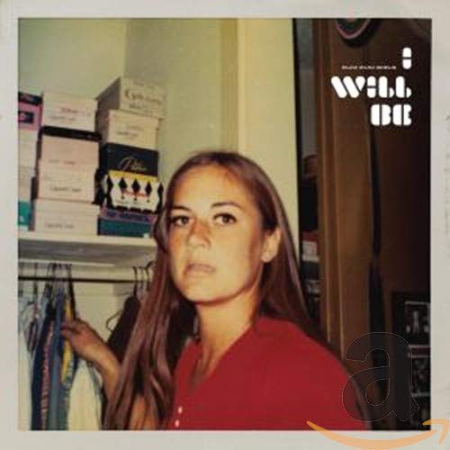 CD cover: woman in red, stacked boxes, and clothing rack.