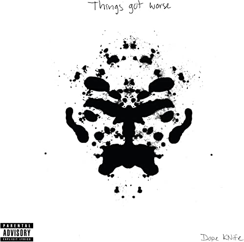 Vinyl record cover with black ink splatter resembling a face.