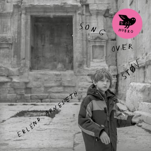 Black and white album cover featuring a young boy in front of ruins.
