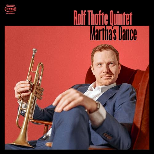 Vinyl album cover featuring a trumpeter seated in a red chair.