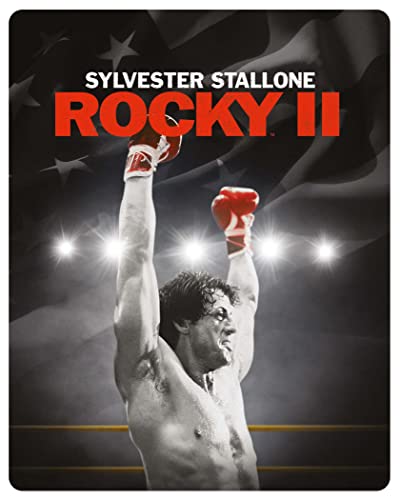 Sylvester Stallone as Rocky Balboa with arms raised in a boxing ring.