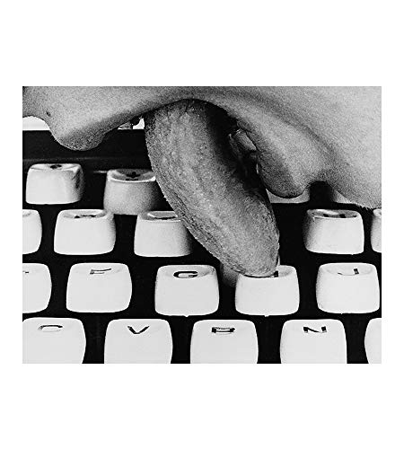 Black and white image of hands typing on a vintage typewriter.