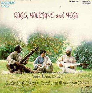 CD cover featuring three musicians with Indian instruments in a garden.
