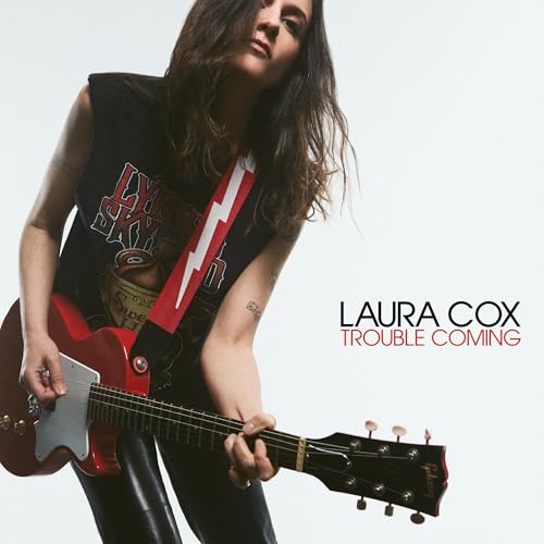 Laura Cox playing a red electric guitar, album cover art.