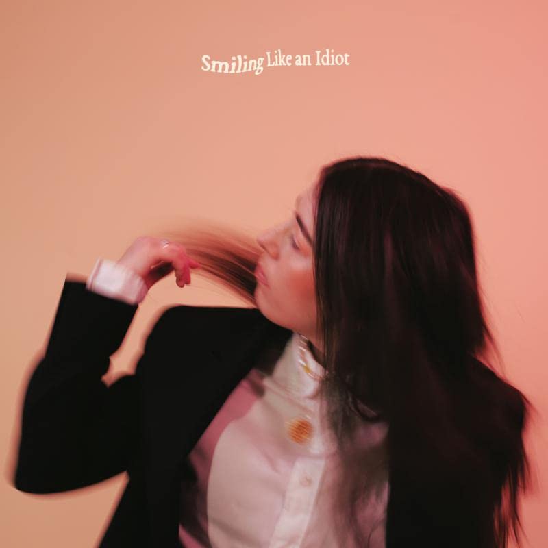 CD cover: Sorcha Richardson, blurred motion, long brown hair, pink background.