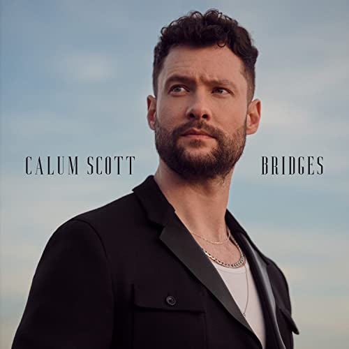 Calum Scott looking away against a sky background on his Bridges album cover.