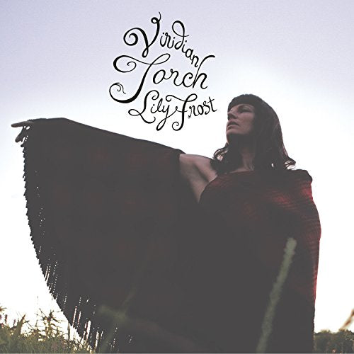 Album cover: woman with dark hair, wrapped in a red shawl.