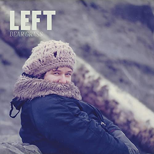 CD cover: person in winter hat and coat, rocky background.