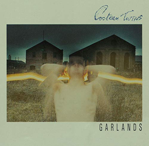 Garlands" album cover: man with blurred face in front of buildings.