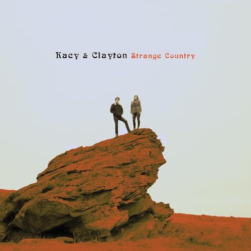Album cover for Kacy & Clayton’s “Strange Country” featuring a duo on a rock.
