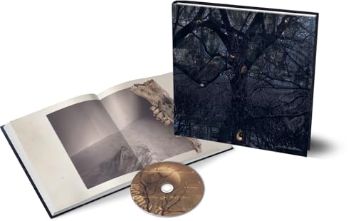 CD packaging with dark forest imagery, an open booklet, and a disc.