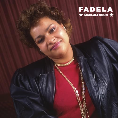 Portrait of Fadela, a woman with curly hair, wearing jewelry.
