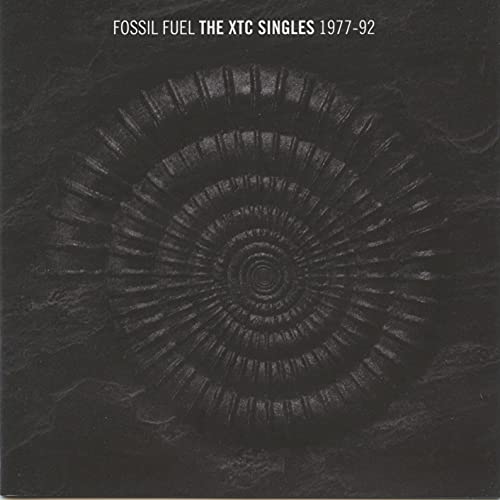 XTC “Fossil Fuel” CD cover: black background with a fossil imprint.