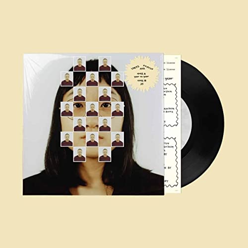 Vinyl record with cover art featuring a face composed of repeated portraits.