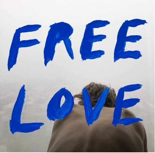 Album cover for Sylvan Esso’s “Free Love” with blue text and a person’s back.