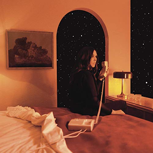Woman with phone sits in arched doorway overlooking a starry night.