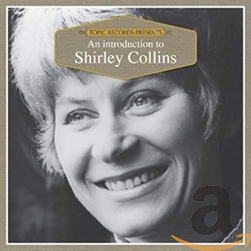 Close-up of Shirley Collins smiling, wearing a white fur trim hat.