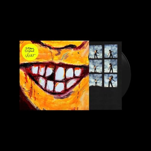 Vinyl record with painted cover featuring a distorted, toothy grin.