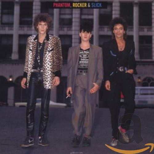 CD cover featuring three men in 1980s fashion on a city street.