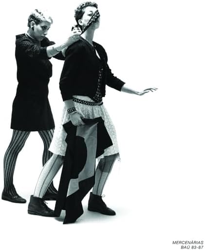 Black and white photo of two women in patterned tights and boots.