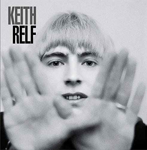 Black and white portrait of Keith Relf with hands framing his face.