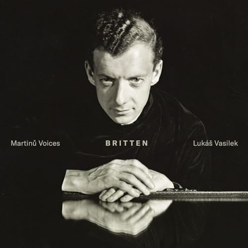 Black and white image of a man with hands on reflective surface and cello.