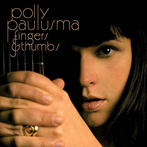 Polly Paulusma album cover featuring a close-up portrait and guitar.