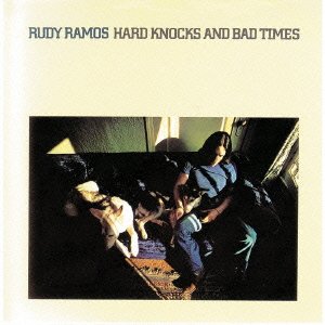 CD cover: man with dogs in a dimly lit room.