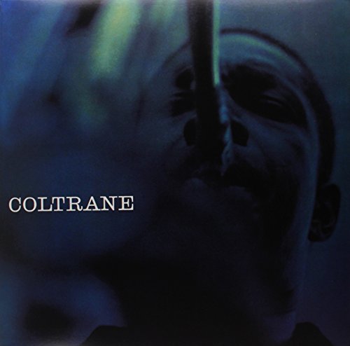 Close-up of John Coltrane playing saxophone, dark blue album cover.