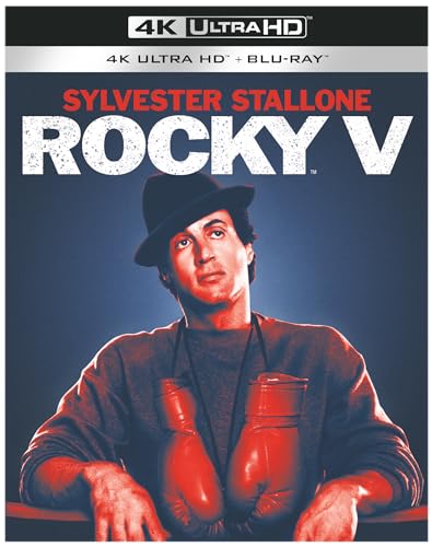 Sylvester Stallone wearing a hat and boxing gloves on the Rocky V movie cover.