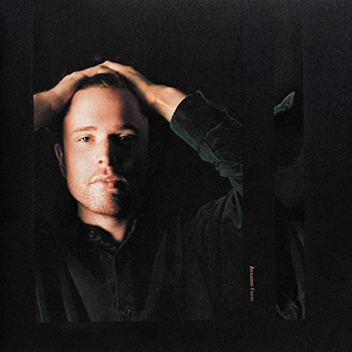 James Blake album cover: portrait of a man with hands near his head.