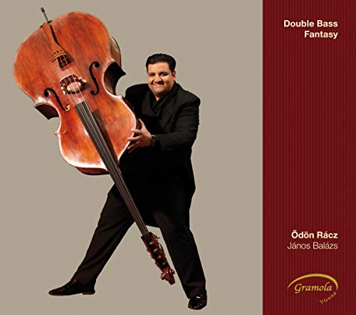 Double bassist Odo Raczjanos Balazs with a large wooden double bass.