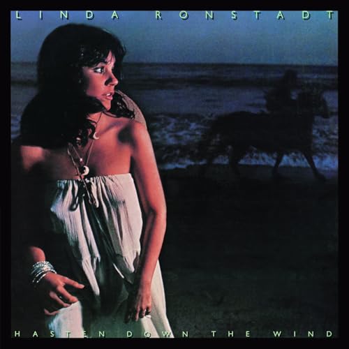 Linda Ronstadt album cover: woman in white dress with horse silhouette.